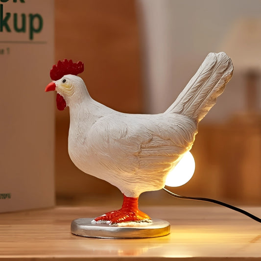 A whimsical chicken butt night light lamp with a detailed sculpture of a chicken, featuring a wooden base and realistic bird elements like a beak, comb, and feathers.