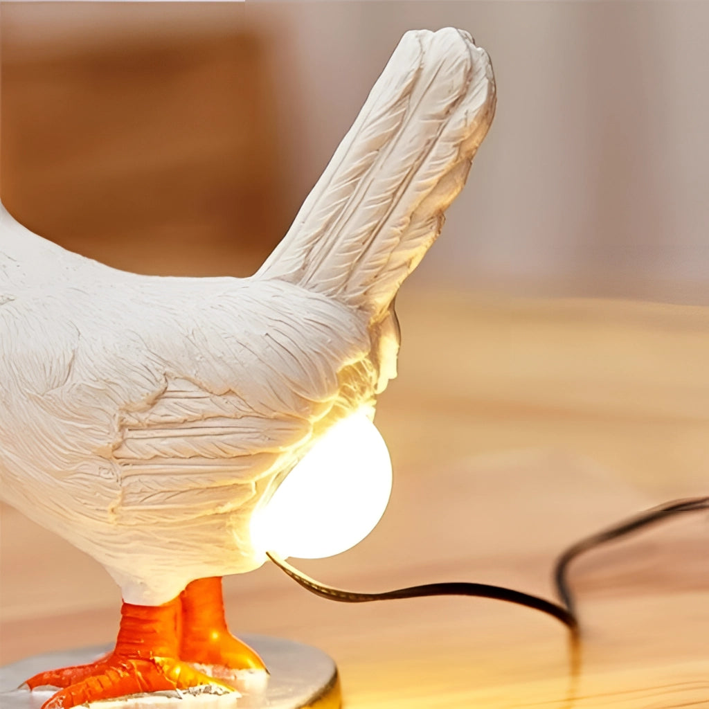 A whimsical chicken-shaped night light lamp made of wood, featuring detailed feathers, beak, and wings, resembling a bird sculpture or toy.