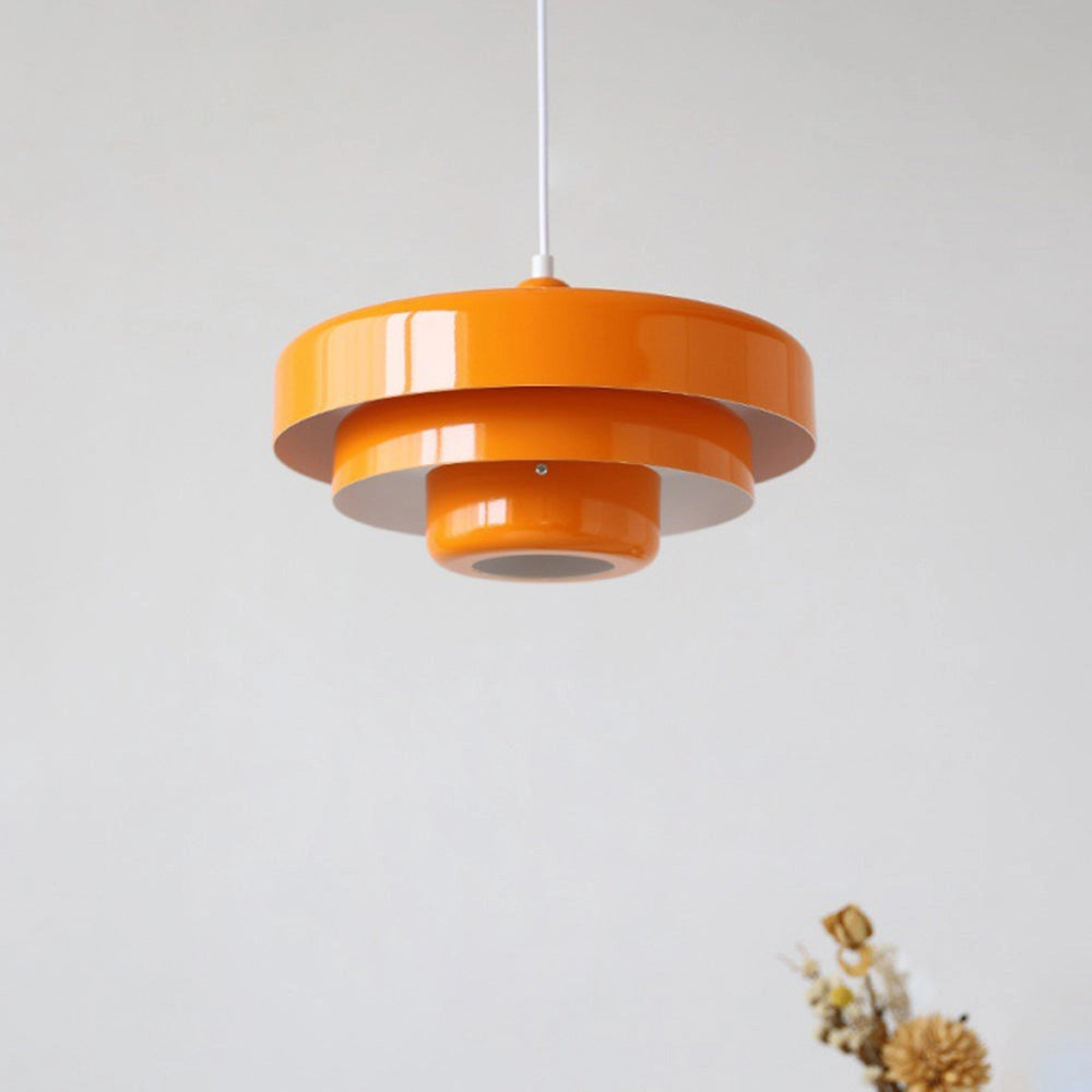 Modern metal pendant lamp featuring a linked circle design, shown in an amber orange finish with switchable color temperatures, suspended from the ceiling with a matching lampshade.