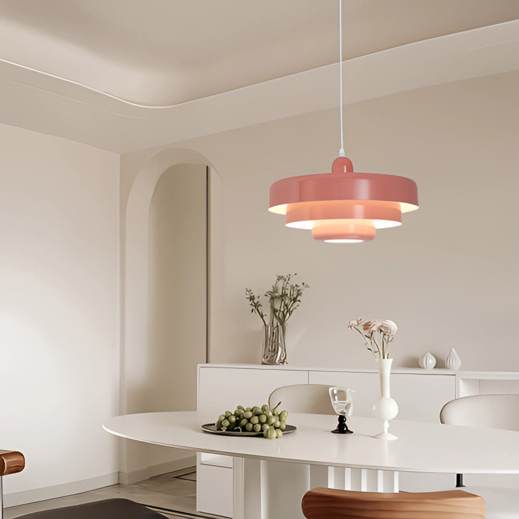 Modern metal pendant lamp with a circular design, featuring switchable three color temperatures, hanging in a stylishly decorated room with wooden furnishings.