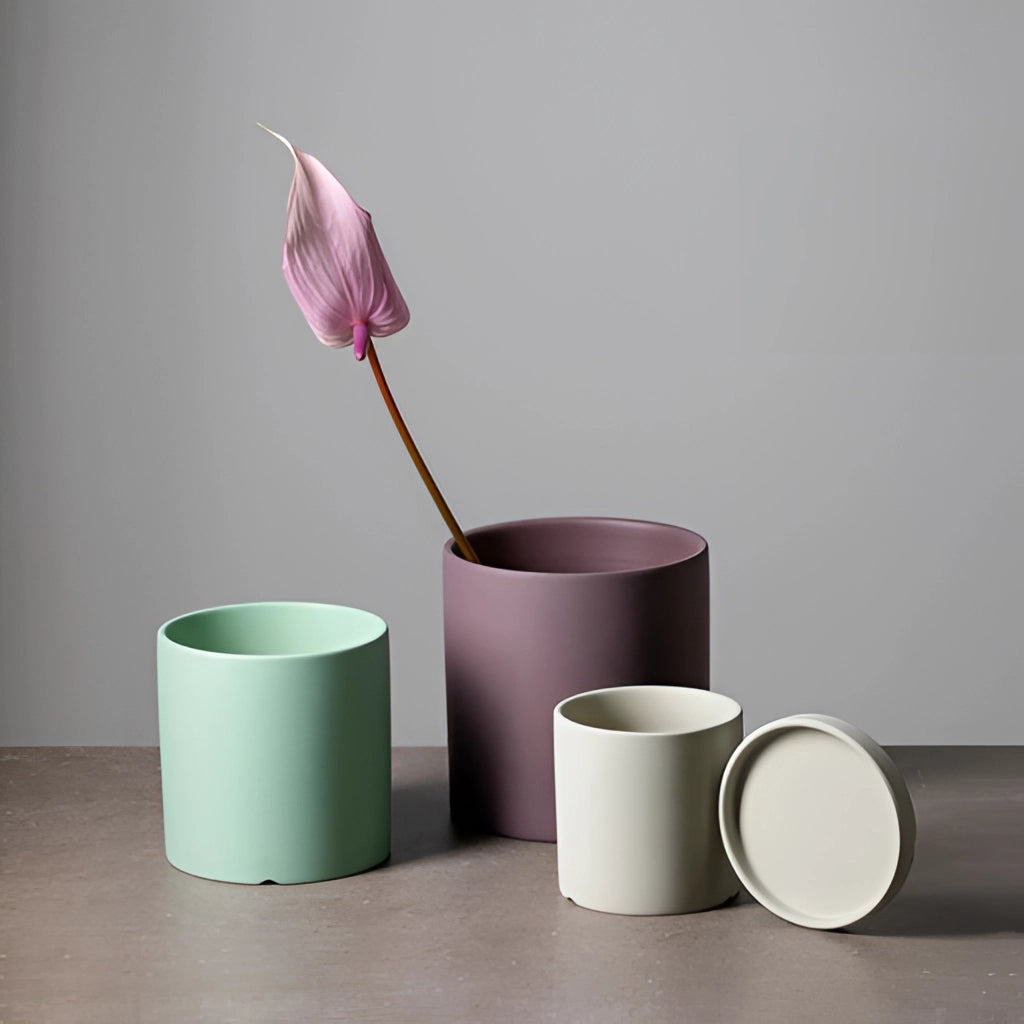 Colorful ceramic planter with matching saucer set, displayed with a small plant on a table.