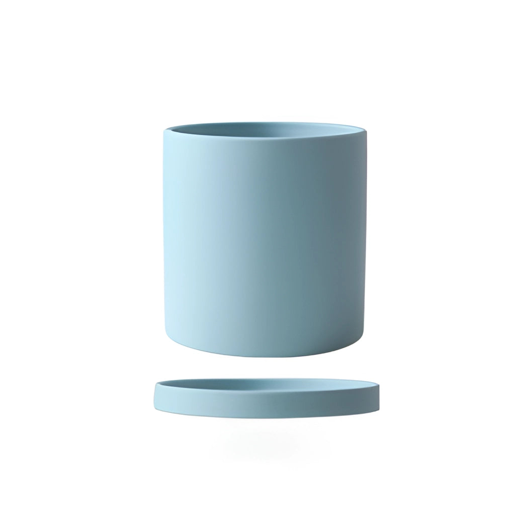 Sky blue large ceramic planter and saucer set on a table.