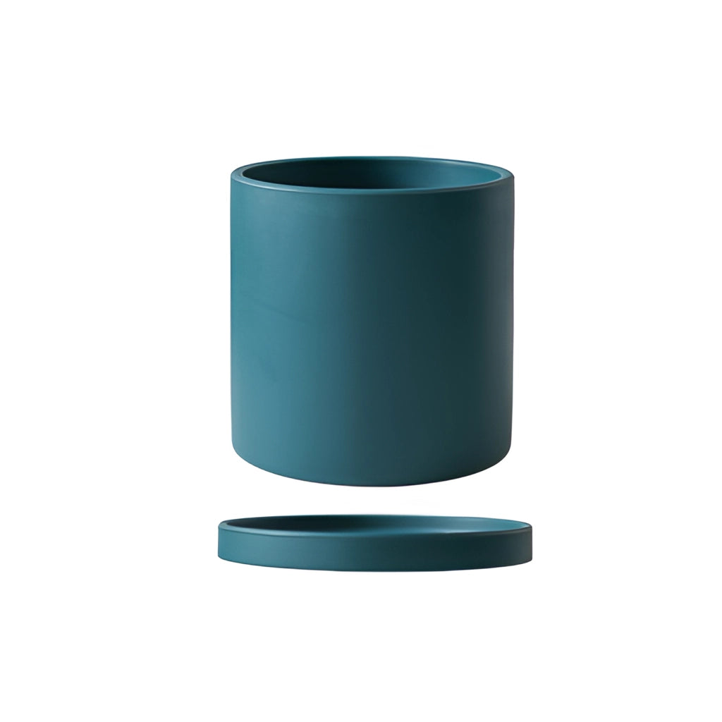 A large teal ceramic planter with a matching saucer.