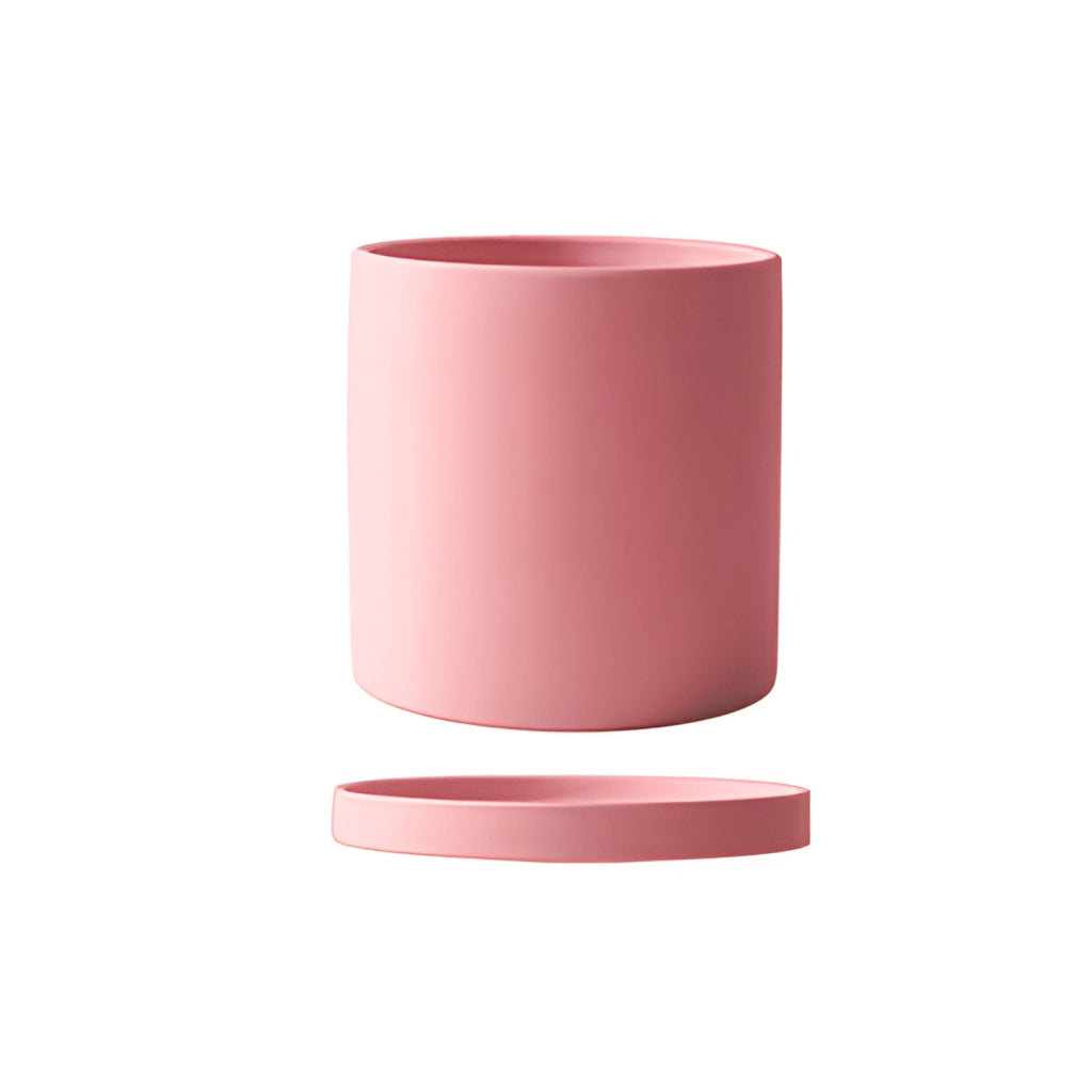 Large pink ceramic planter and saucer set with a colorful design.