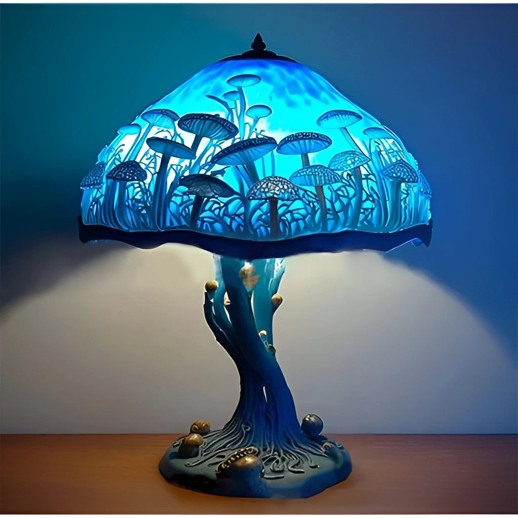 A decorative stained glass table lamp shaped like a colorful mushroom, featuring shades of white, blue, azure, and purple with a glowing light.