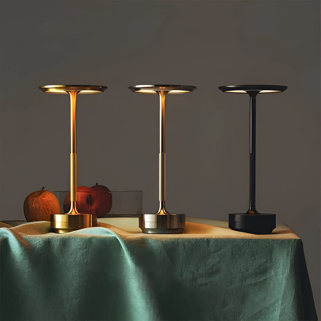 Contemporary LED desk light with touch control on a wooden table alongside drinkware and tablecloth, providing ambient lighting.