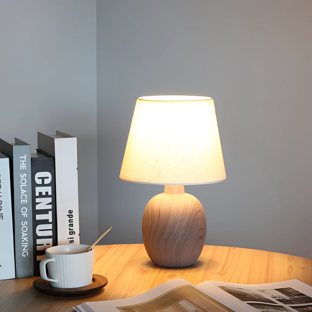 Contemporary rechargeable table lamp with a unique style, placed on a wooden table in a modern interior setting.