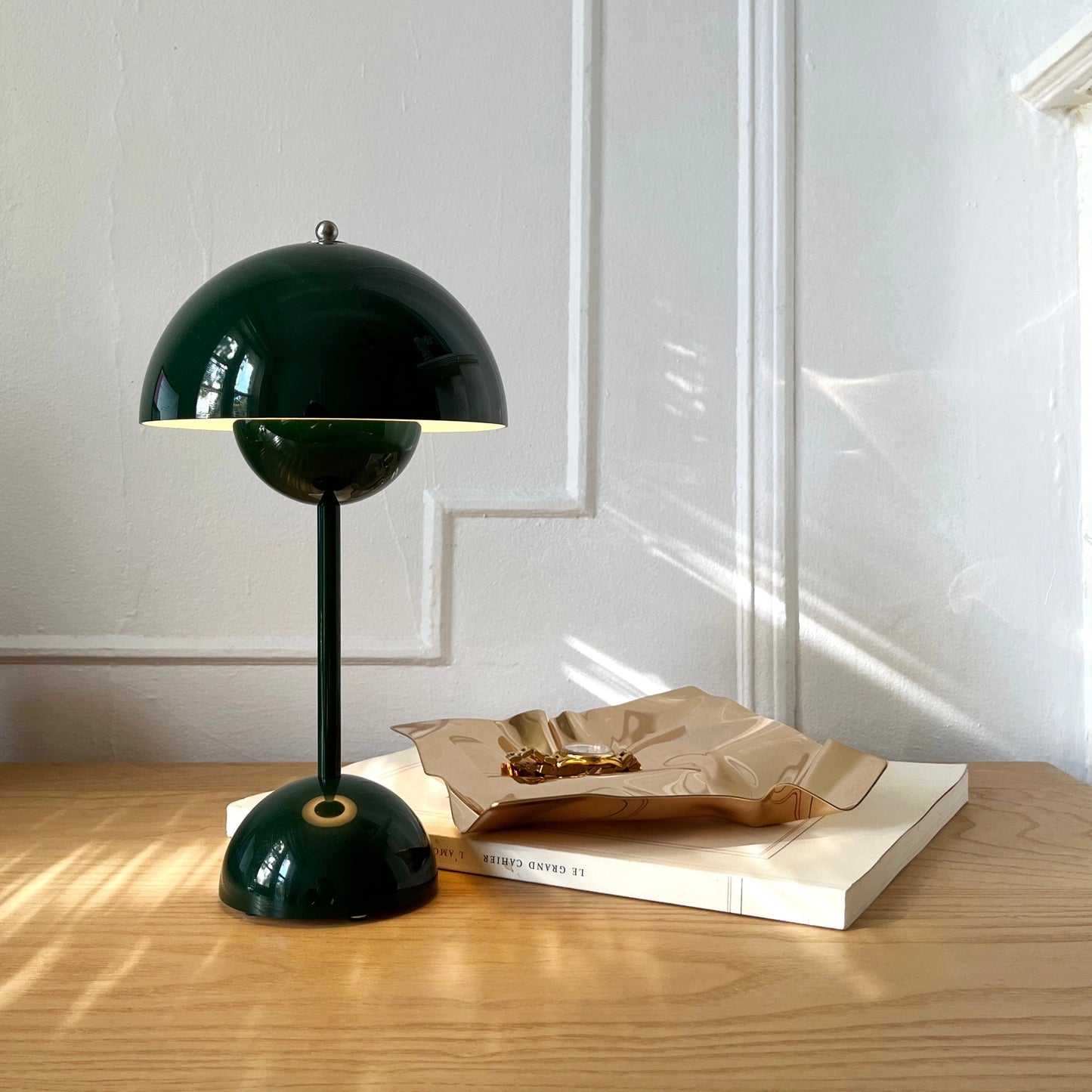 Cordless flowerpot table lamp with touch sensor, placed on a wooden table with hardwood flooring in the background.