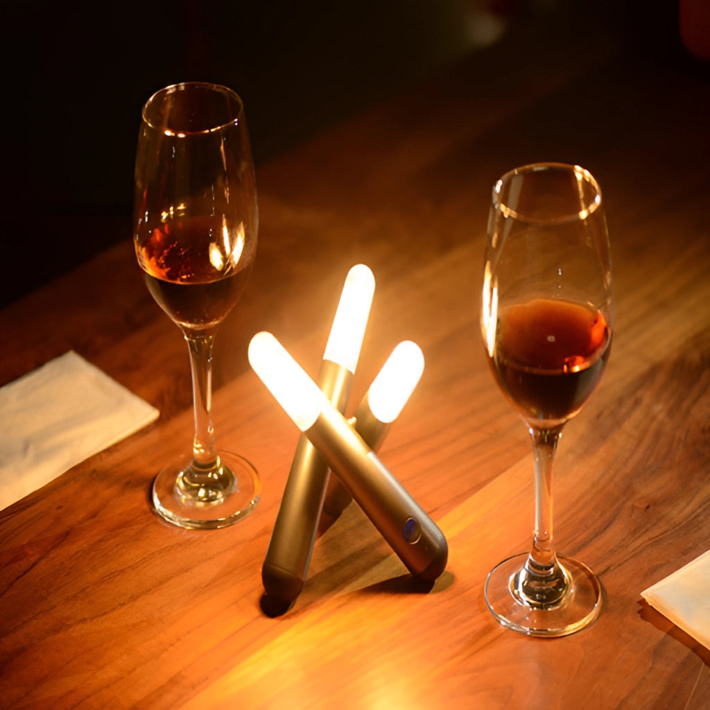 Cordless Kinetic Rotation LED Table Lamp on a table with various wine glasses and drinkware.