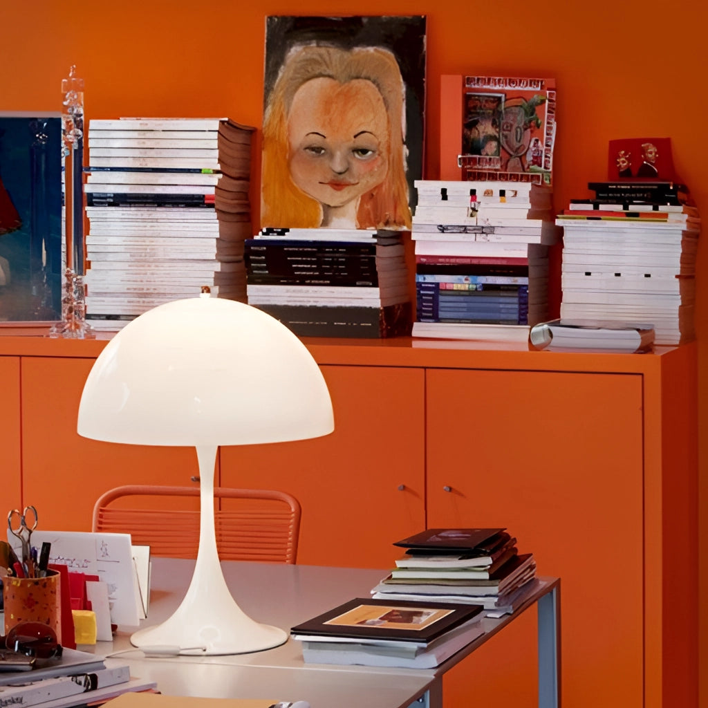 Cordless LED table lamp with rechargeable battery placed on a modern desk surrounded by shelves filled with books and decorative items in a stylish, well-lit interior.