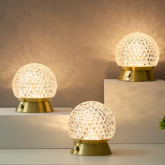 Modern cordless rechargeable table lamp with LED dimmable light, rectangular base, and gold accents on a table in an interior design setting.