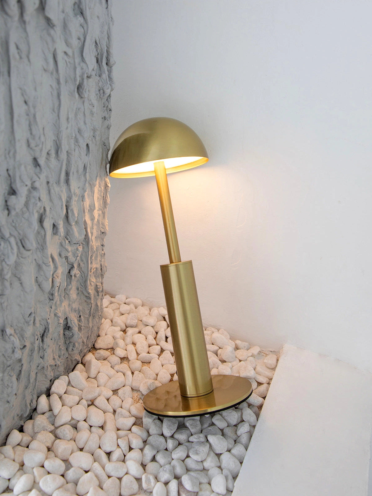 Cordless rechargeable table lamp with unique sculptural design featuring a wooden base and a metal lampshade.