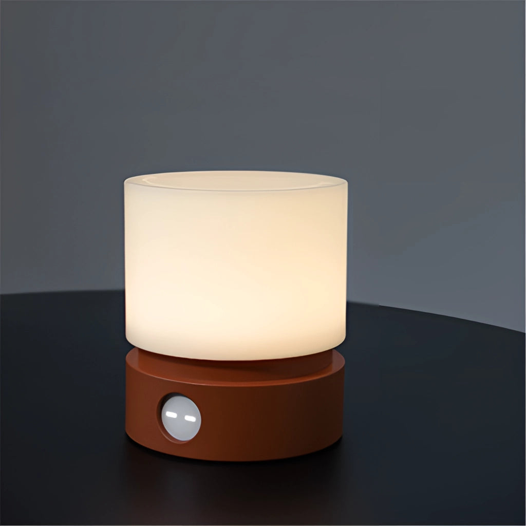 Cordless table lamp with long battery life and adjustable brightness, featuring a rectangular wooden base and a cylindrical porcelain shade.