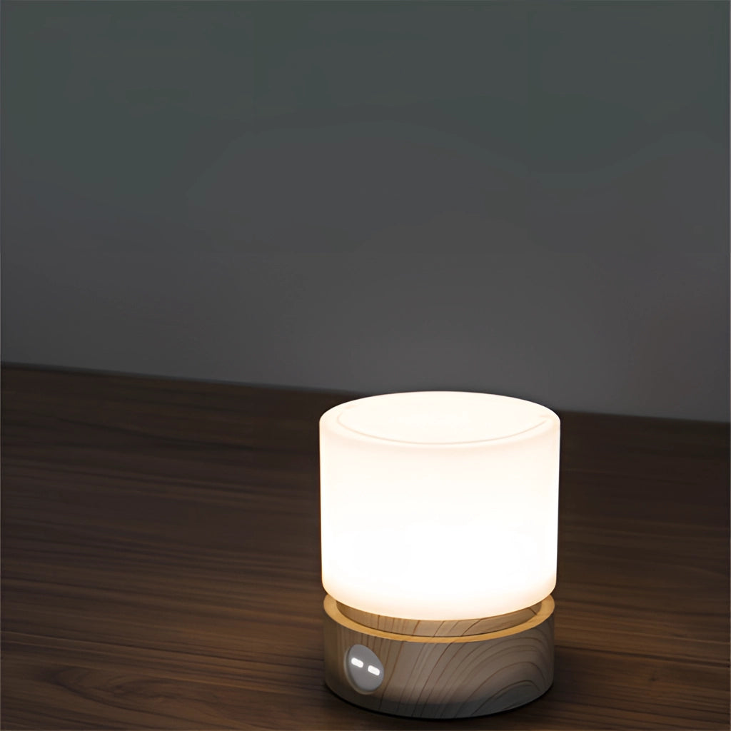 Cordless table lamp with long battery life and adjustable brightness, featuring a sleek cylindrical design and wooden base.