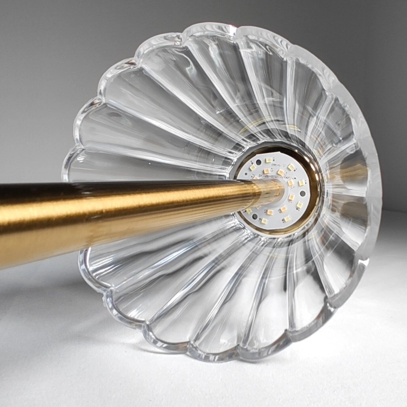 Cordless table lamp with a silver, circular base and sleek, modern design.