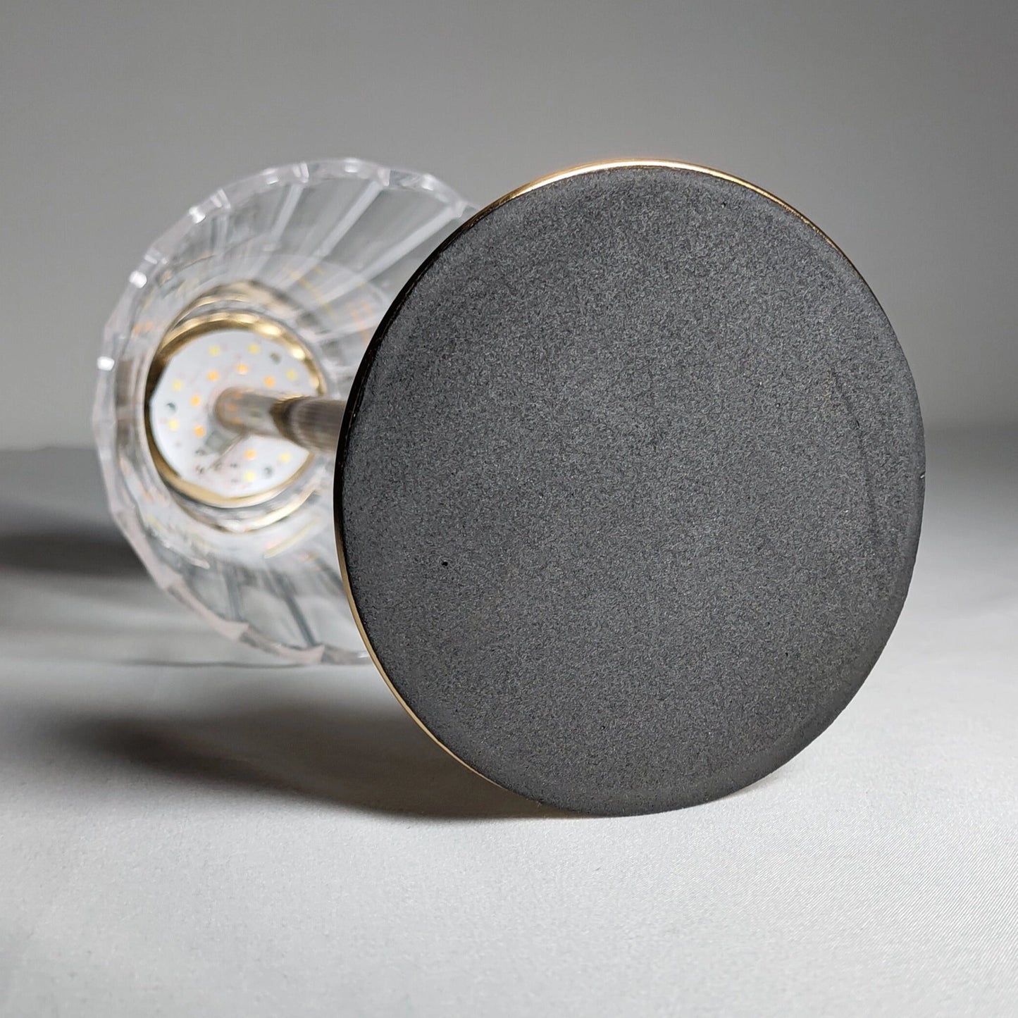 Cordless table lamp with a sleek, cylindrical design, featuring a durable and elegant body.