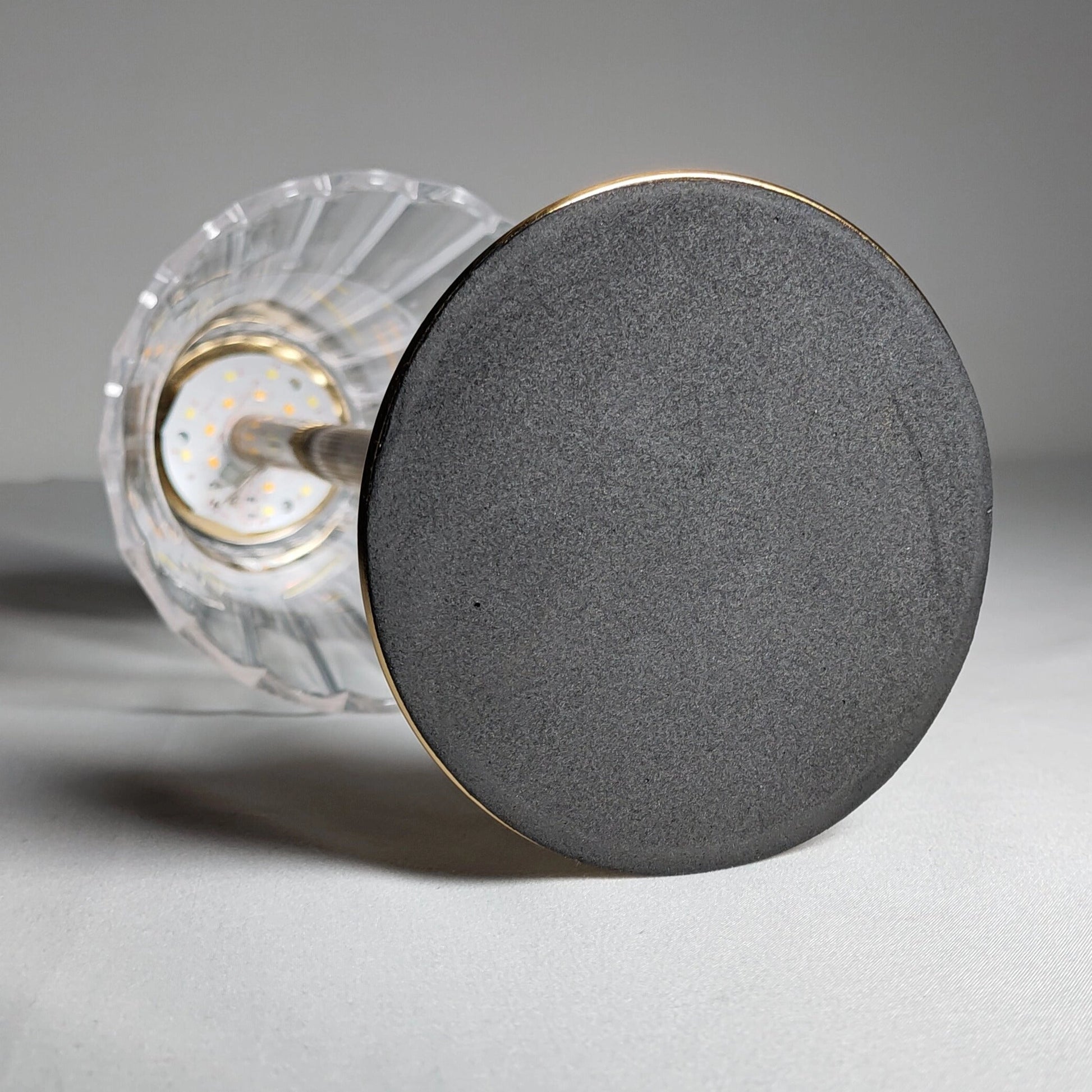 Cordless table lamp with a sleek, cylindrical design, featuring a durable and elegant body.