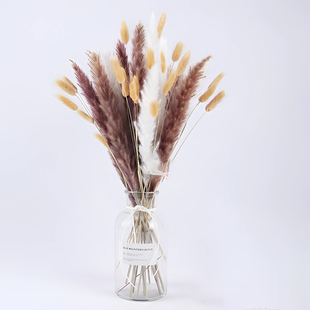 A 30-piece set of dried pampas grass flowers arranged in a stylish vase, displayed on a wooden table with minimalistic tableware, enhancing interior decoration with natural, earthy tones.