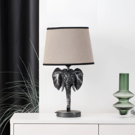 Elephant design lamp with a rectangular lampshade, featuring a combination of glass and metal materials, and a rechargeable battery.