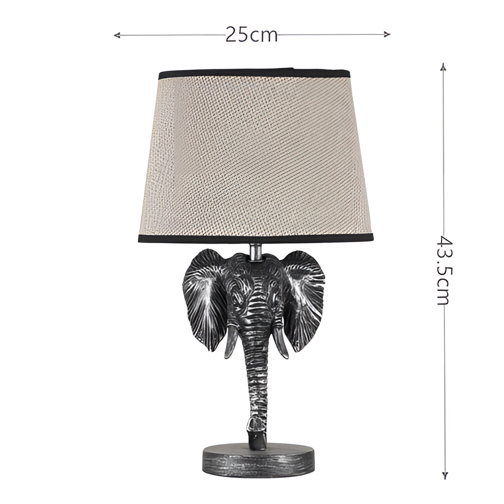 Elephant Design Lamp with Rechargeable Battery featuring a blue elephant shape, sitting on a rectangular base, surrounded by plants.