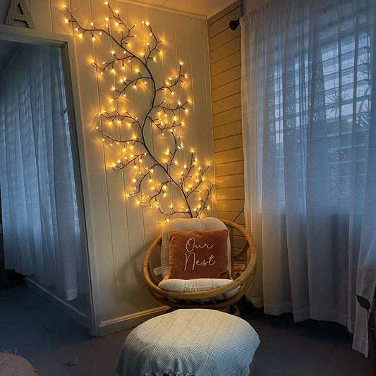 Enchanted Willow Vine Light Freya illuminating a tranquil interior space with elegant wood and textile decorations, featuring curtains and a well-designed flooring.
