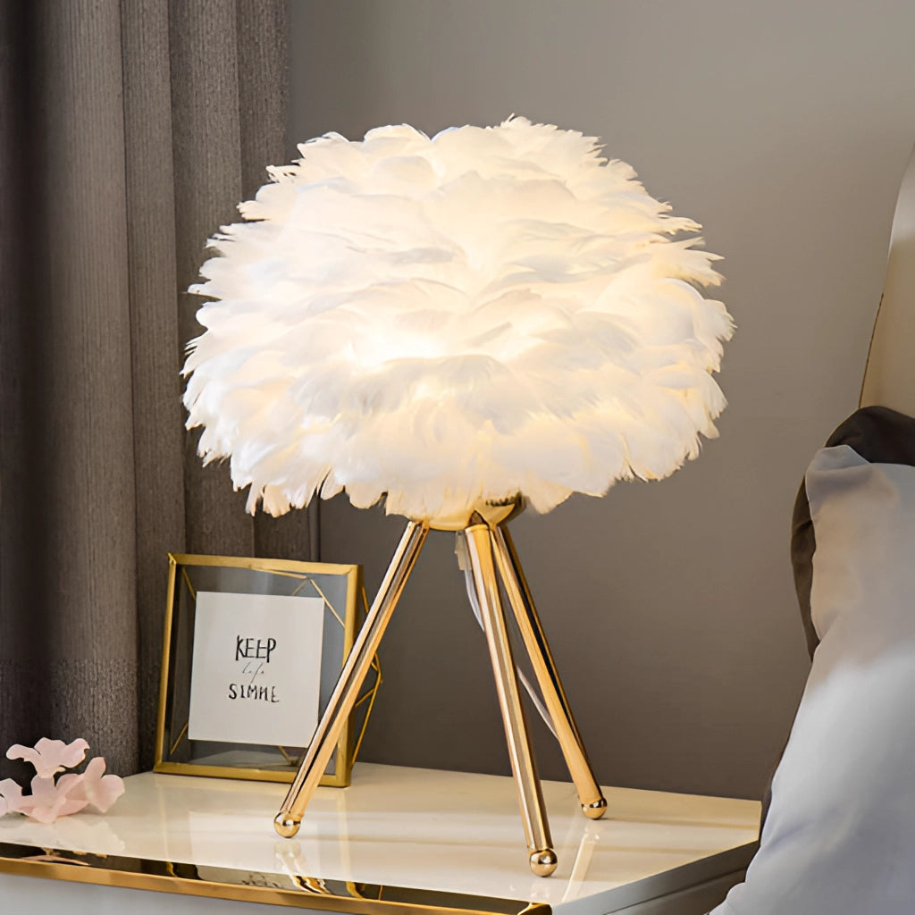 White Feather LED Table Lamp with Dimmable Lighting on a table, surrounded by modern interior decor including a plant, picture frame, and a window with curtains.
