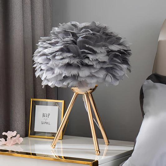 Gray Feather LED Table Lamp with Dimmable Lighting on a modern table, surrounded by stylish interior decor including a plant and a flower arrangement.