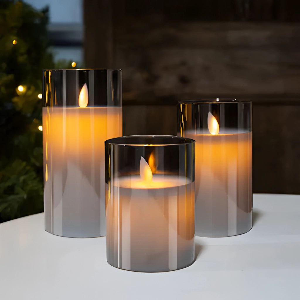 Three-piece flameless LED glass pillar candle set with remote control, featuring realistic wax-like texture and a warm glow.