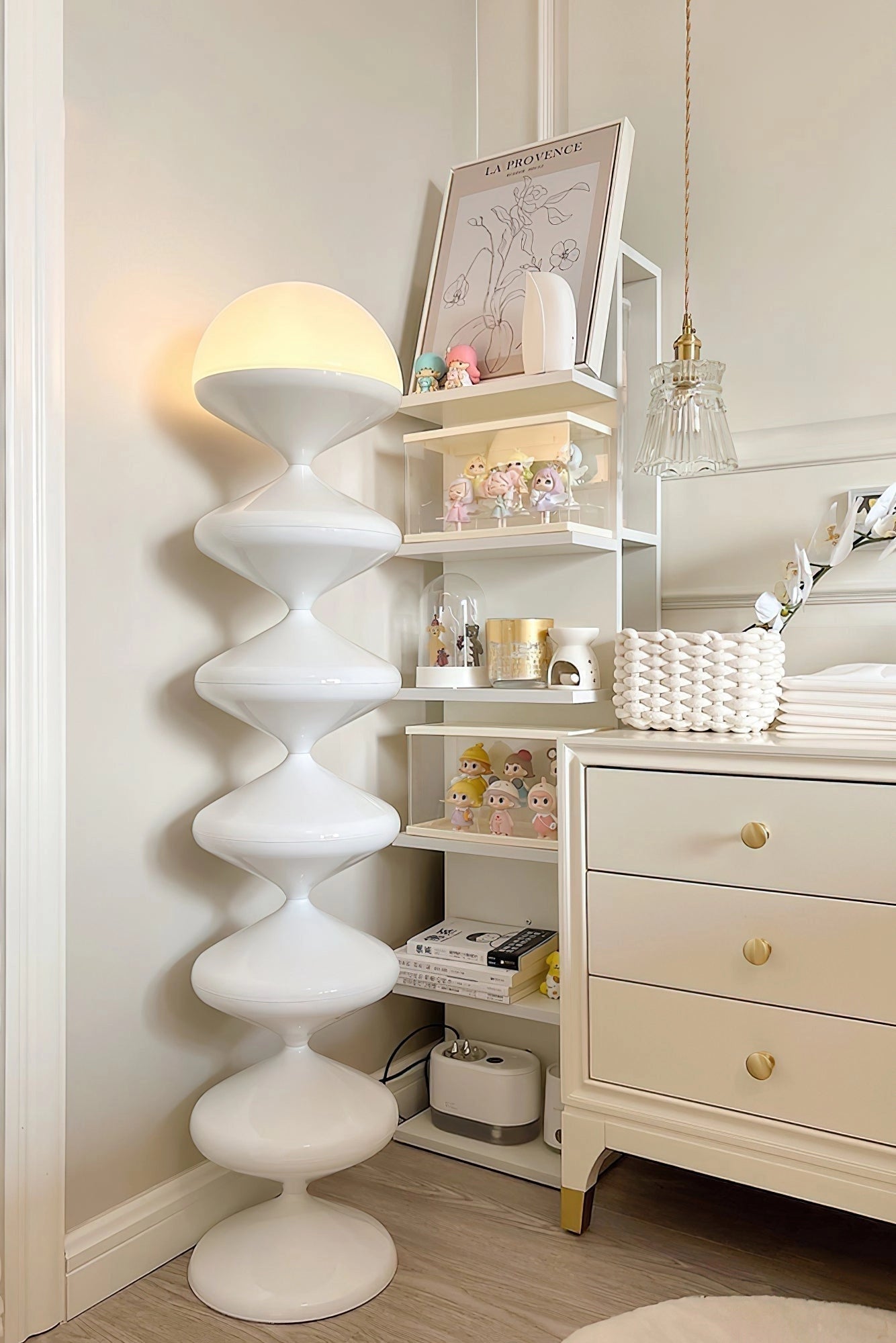 Modern floor lamp with a twisted gourd design in a stylish interior setting featuring wooden cabinetry and shelving.