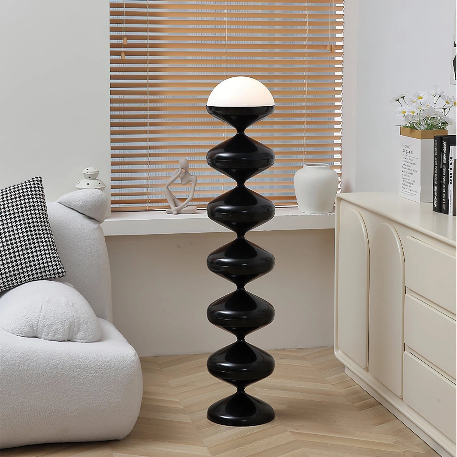 Modern elegant floor lamp with twisted gourd design, placed in a stylish interior setting with wooden flooring and shelving units.