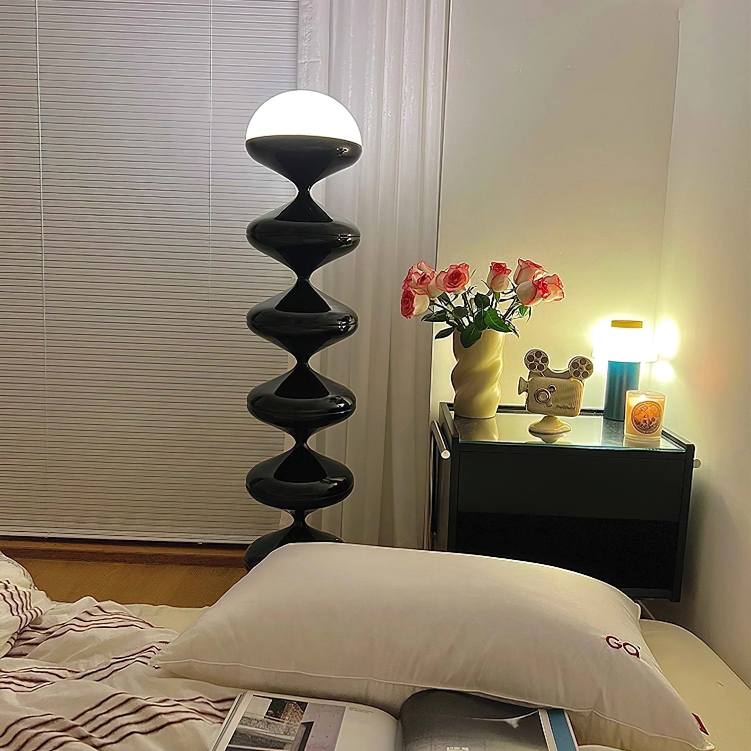 Modern elegant floor lamp with twisted gourd design, featuring a wooden base, illuminating an interior space with stylish lighting and enhancing comfort and interior design aesthetics.