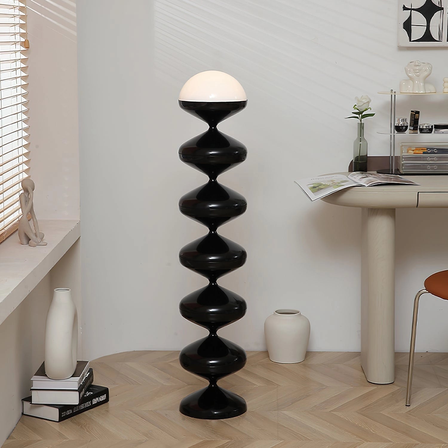 Modern floor lamp with twisted gourd design, featuring elegant white and wood elements, placed in a stylish interior setting with hardwood flooring and shelving.