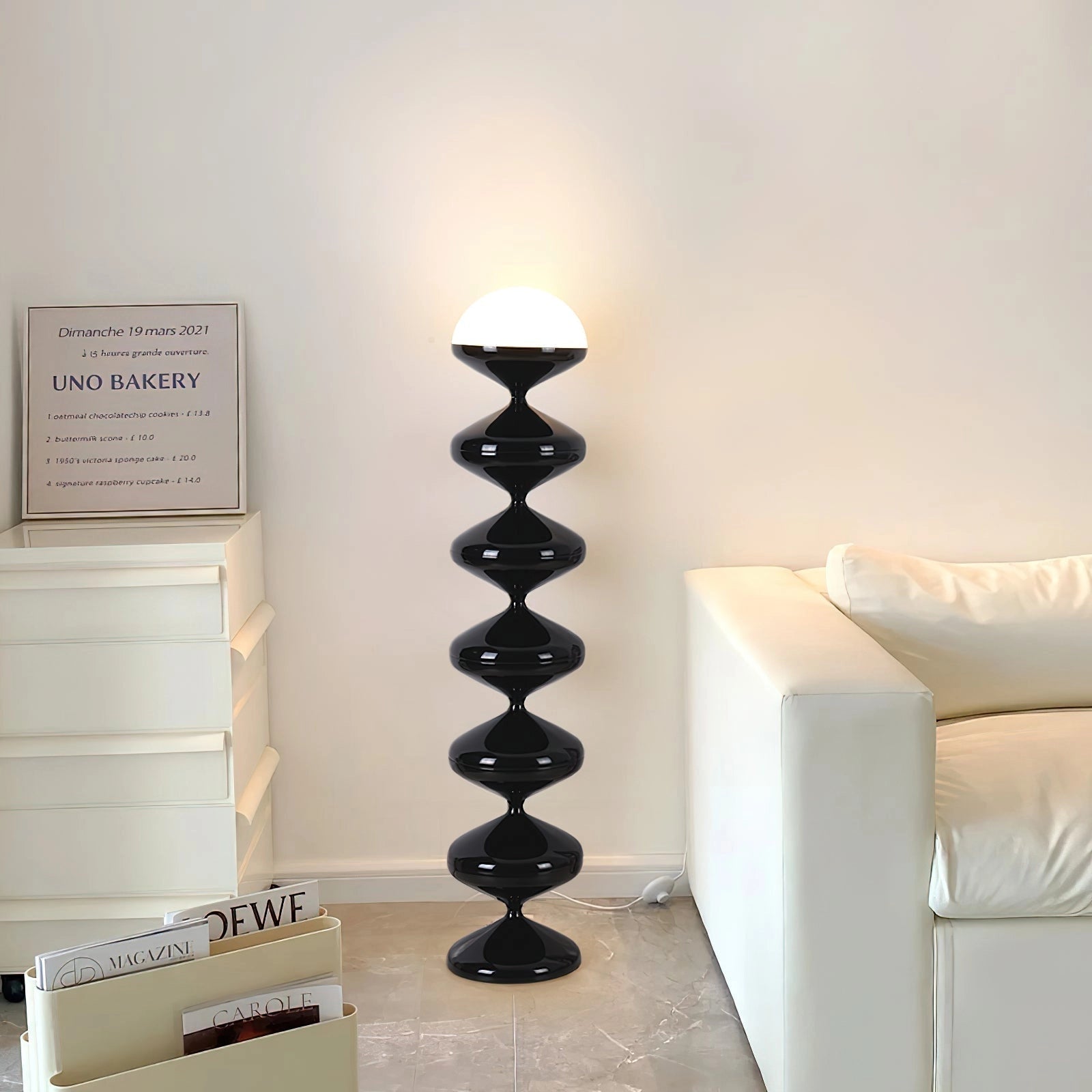Modern elegant floor lamp with twisted gourd design, positioned next to a wooden shelf unit in a well-decorated interior space.