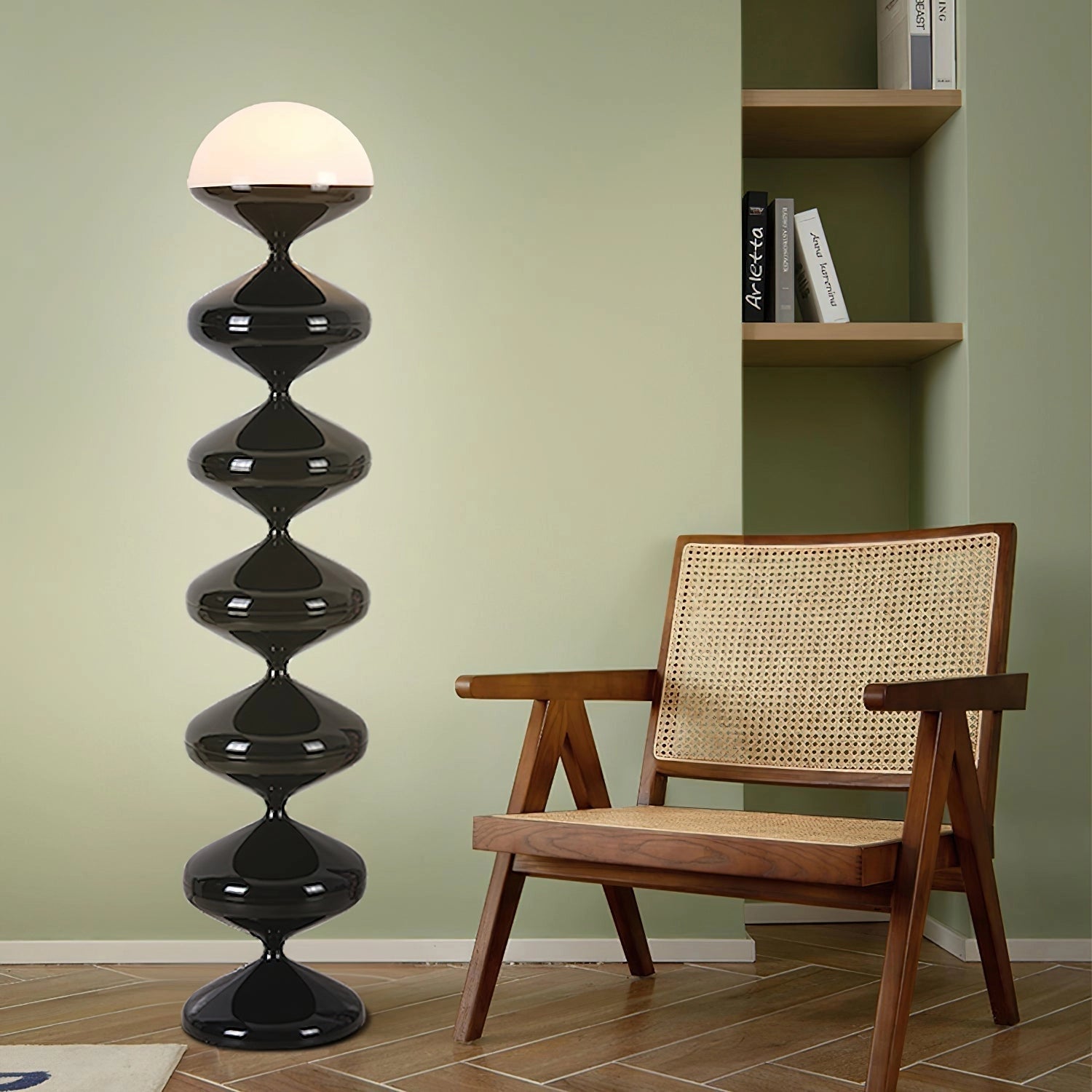 Modern elegant floor lamp with twisted gourd design placed next to a wooden bookshelf and chair on hardwood flooring.
