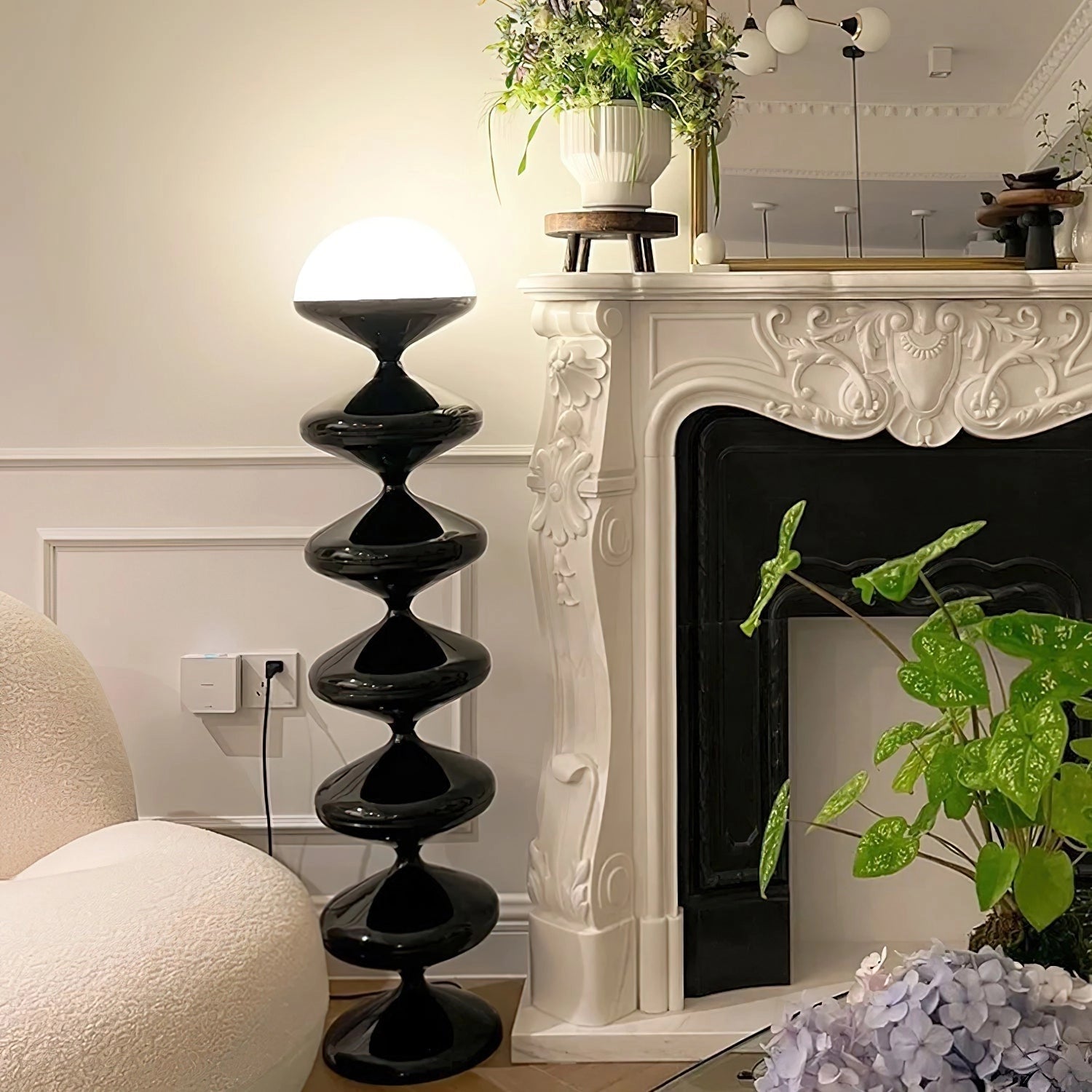 Modern floor lamp with twisted gourd design, placed in a stylish interior setting with houseplants, wooden shelves, and flowerpots.