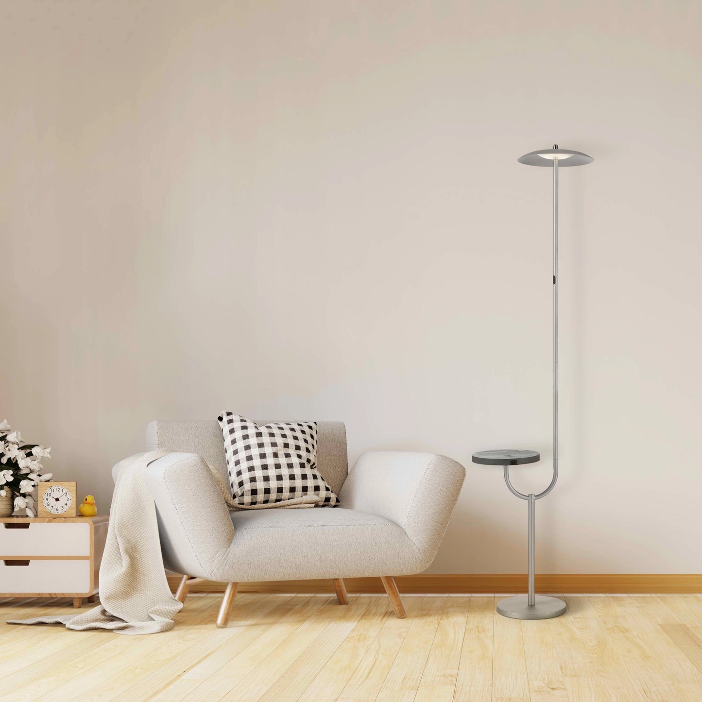 A modern floor lamp with a wooden table top shelf and wireless charging feature, positioned next to a grey couch in a comfortable interior design setting.