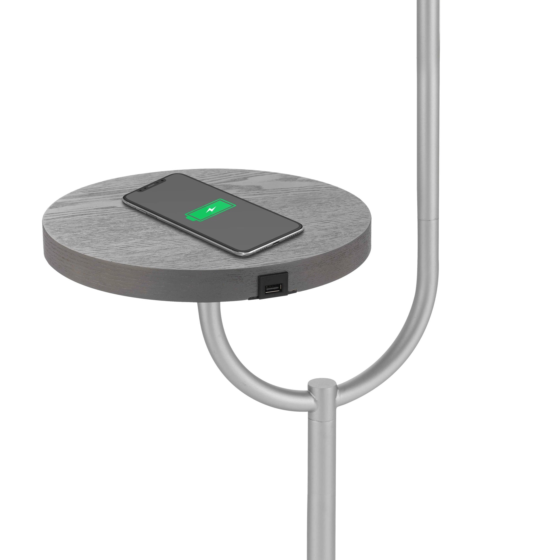 Modern floor lamp with a built-in wireless charging station, featuring a table top shelf with a watch and other small gadgets placed on it.