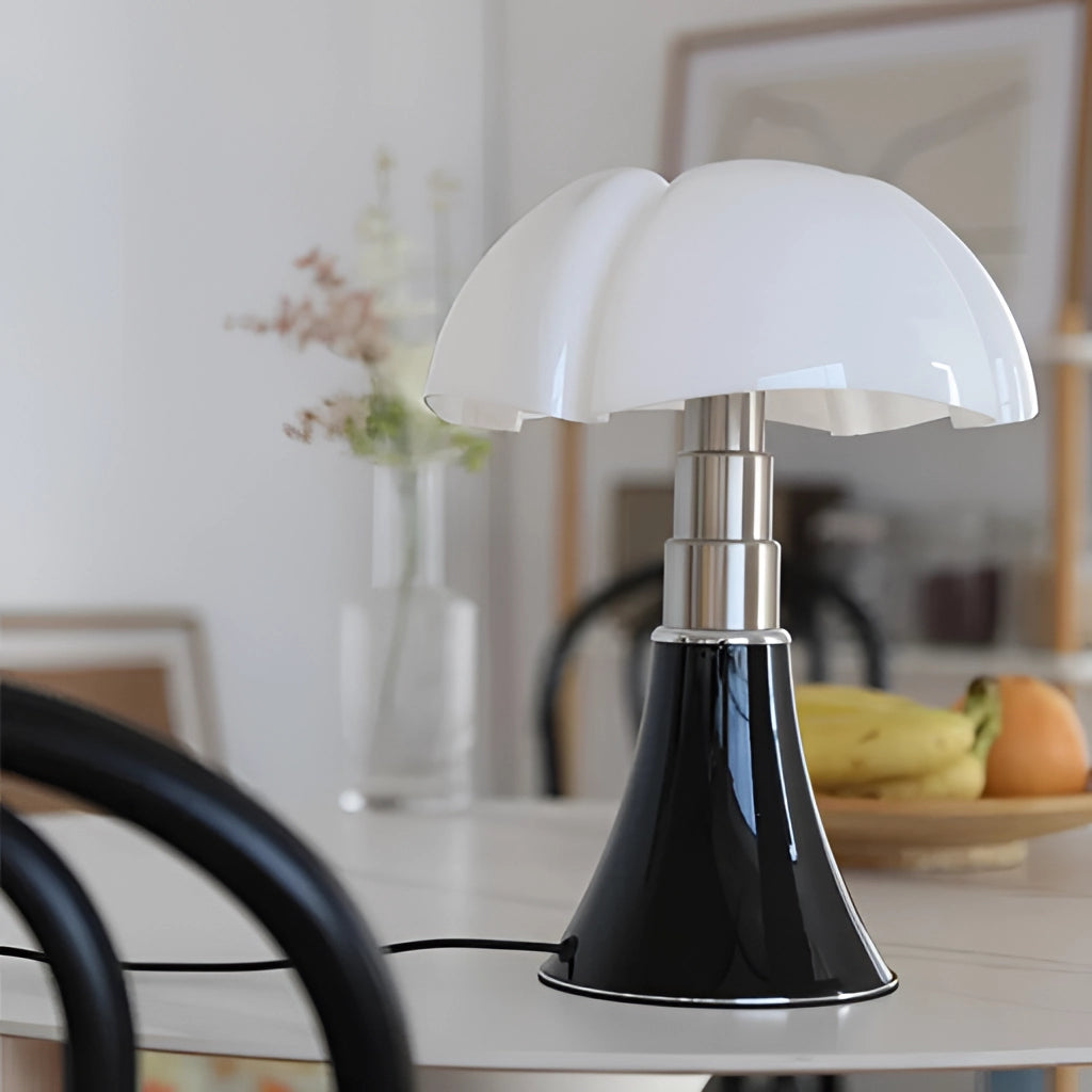 Floral design table lamp with adjustable height and LED light placed on a wooden table, featuring a lampshade with floral patterns and surrounded by wooden flooring and a potted plant.