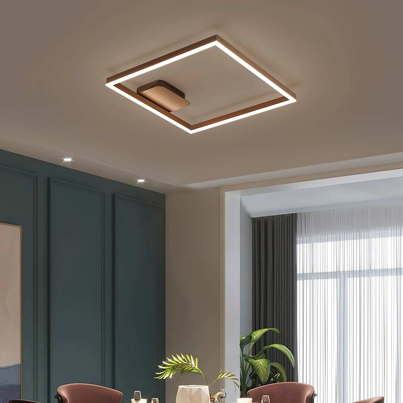 Modern geometric aluminum pendant light with LED technology, illuminating a stylish interior with wooden furniture, a plant, and large windows.
