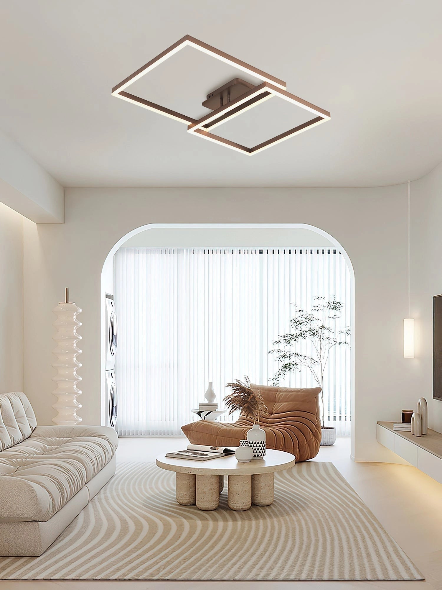 Modern geometric aluminum pendant light with LED technology hanging in a stylish interior with wooden flooring, large windows, and contemporary furniture.