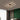 Modern artistic geometric aluminum pendant light with LED technology illuminating a stylish interior space featuring a comfortable couch, wooden accents, and contemporary decor.