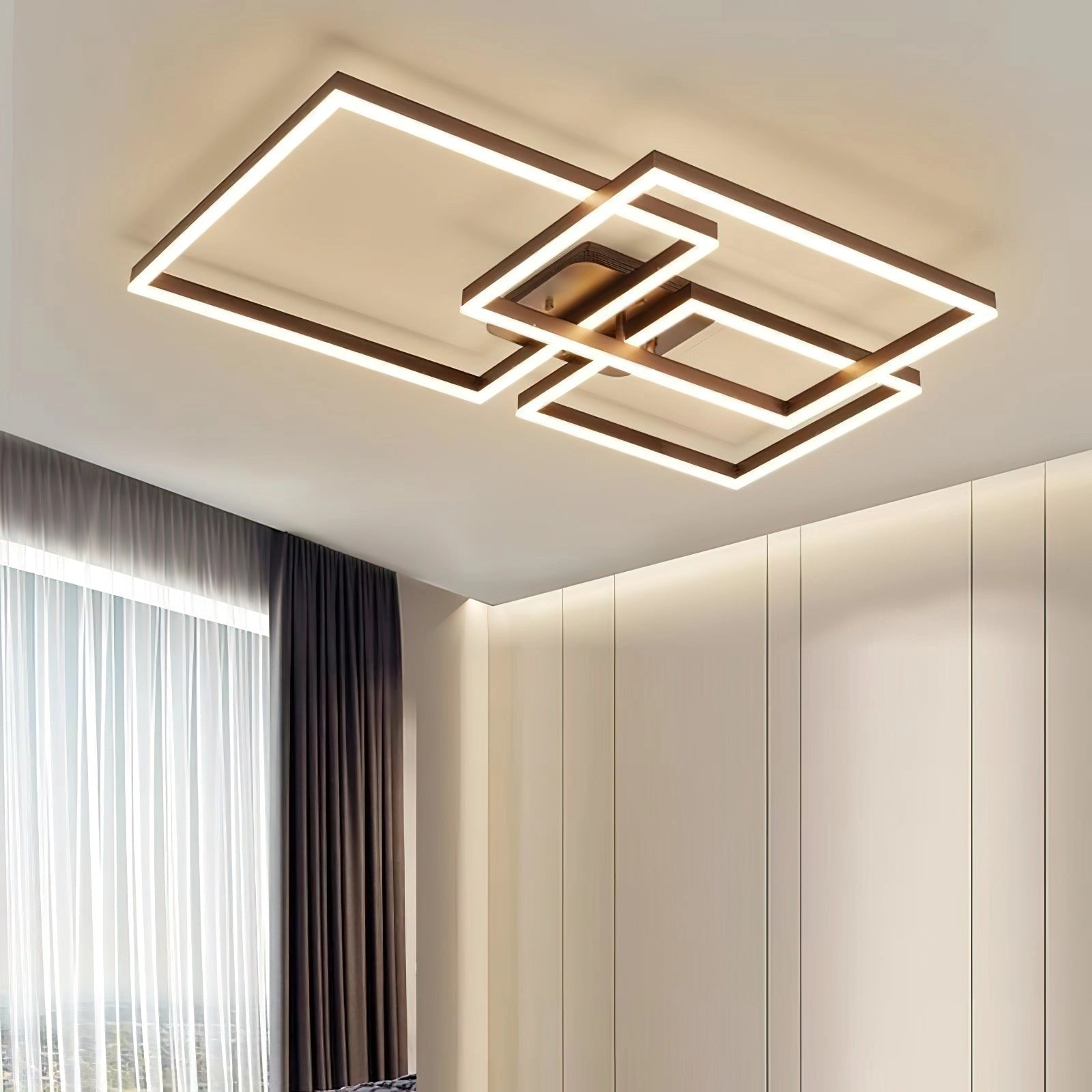 Geometric Aluminum Pendant Light with LED Technology hanging from a ceiling, featuring a modern artistic design with a rectangular shape. The background includes wooden elements and curtains.