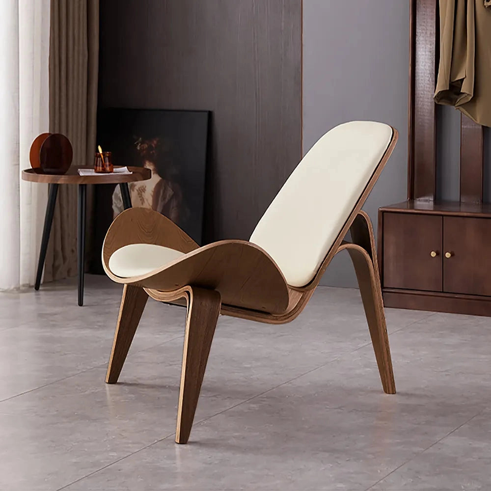 Geometric Retro Accent Chair with wooden legs in a modern interior space, featuring hardwood flooring, a table, and curtains in the background.