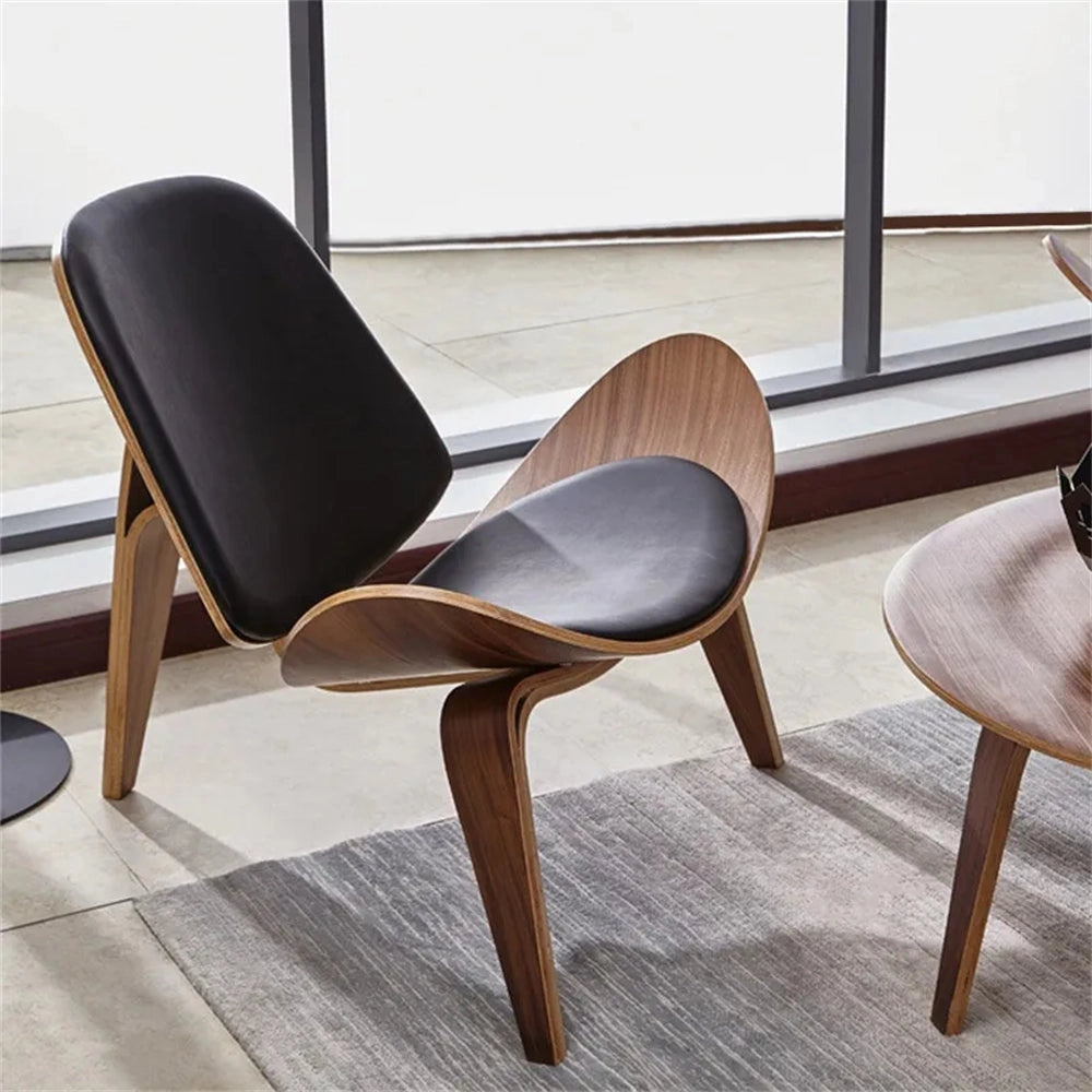 Geometric retro accent chair with wooden armrests and legs, placed on a hardwood floor.