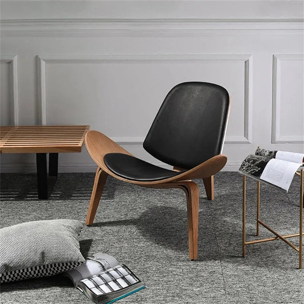 Geometric Retro Accent Chair in Black with wooden armrests and legs, placed on a grey hardwood floor in a modern interior setting.