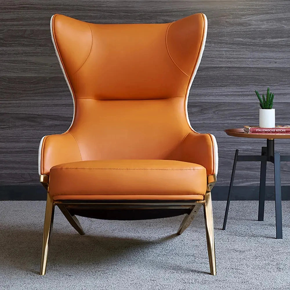 Geometric Wingback Accent Chair with gold trestle base, featuring wooden armrests, set in a stylish interior design setting.