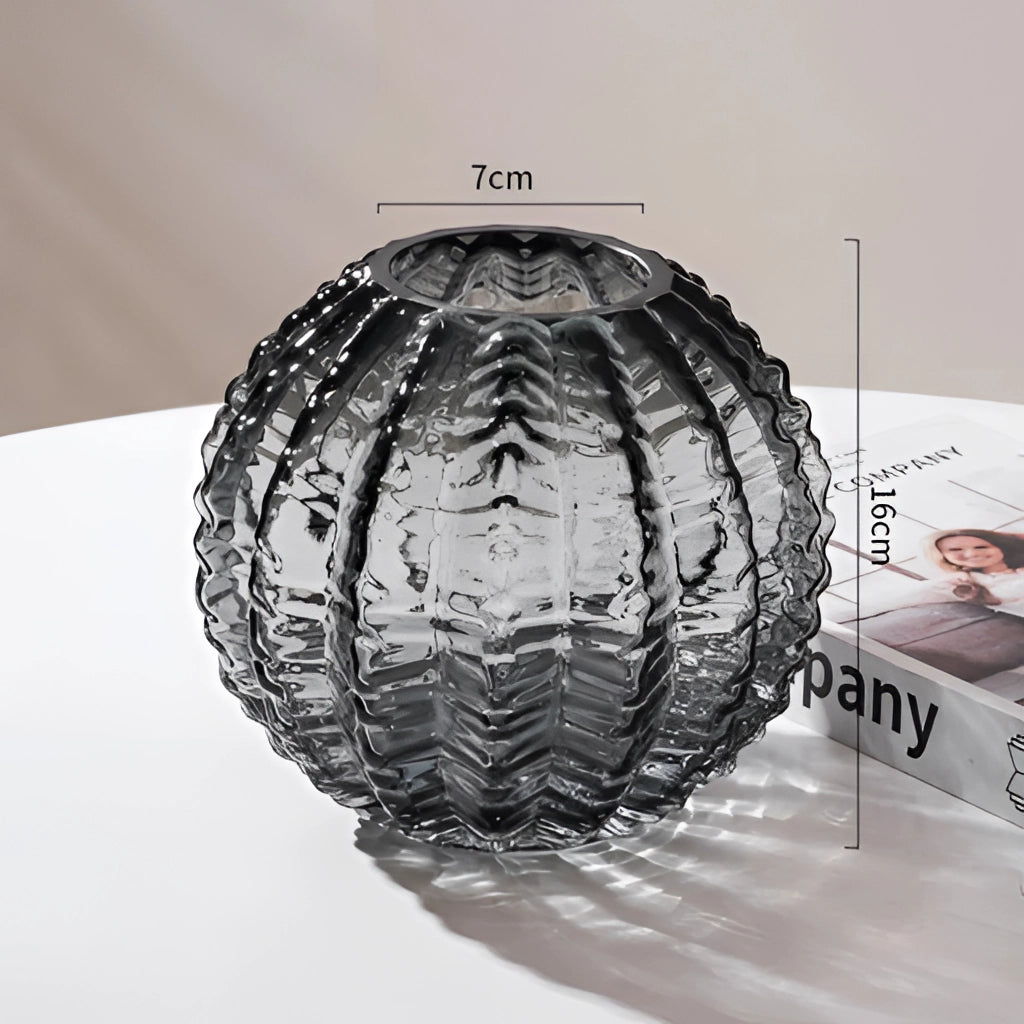 A small gray glass vase shaped like a cactus, featuring a sleek and modern design with symmetrical details.