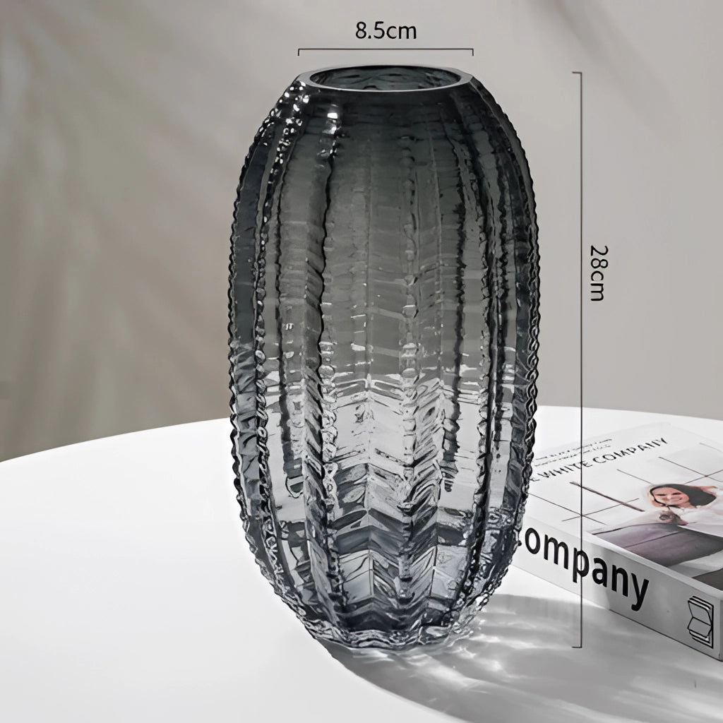 Gray large glass cactus vase filled with water, featuring a symmetrical design, circular base, and artistic tints and shades.