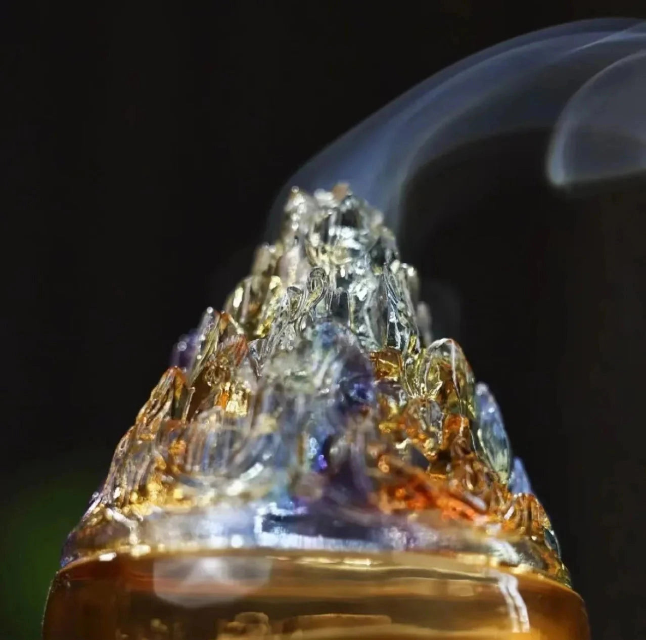 Close-up of a glass incense burner with an amber-colored fluid inside, showcasing its transparent material and natural design for Zen home decor.