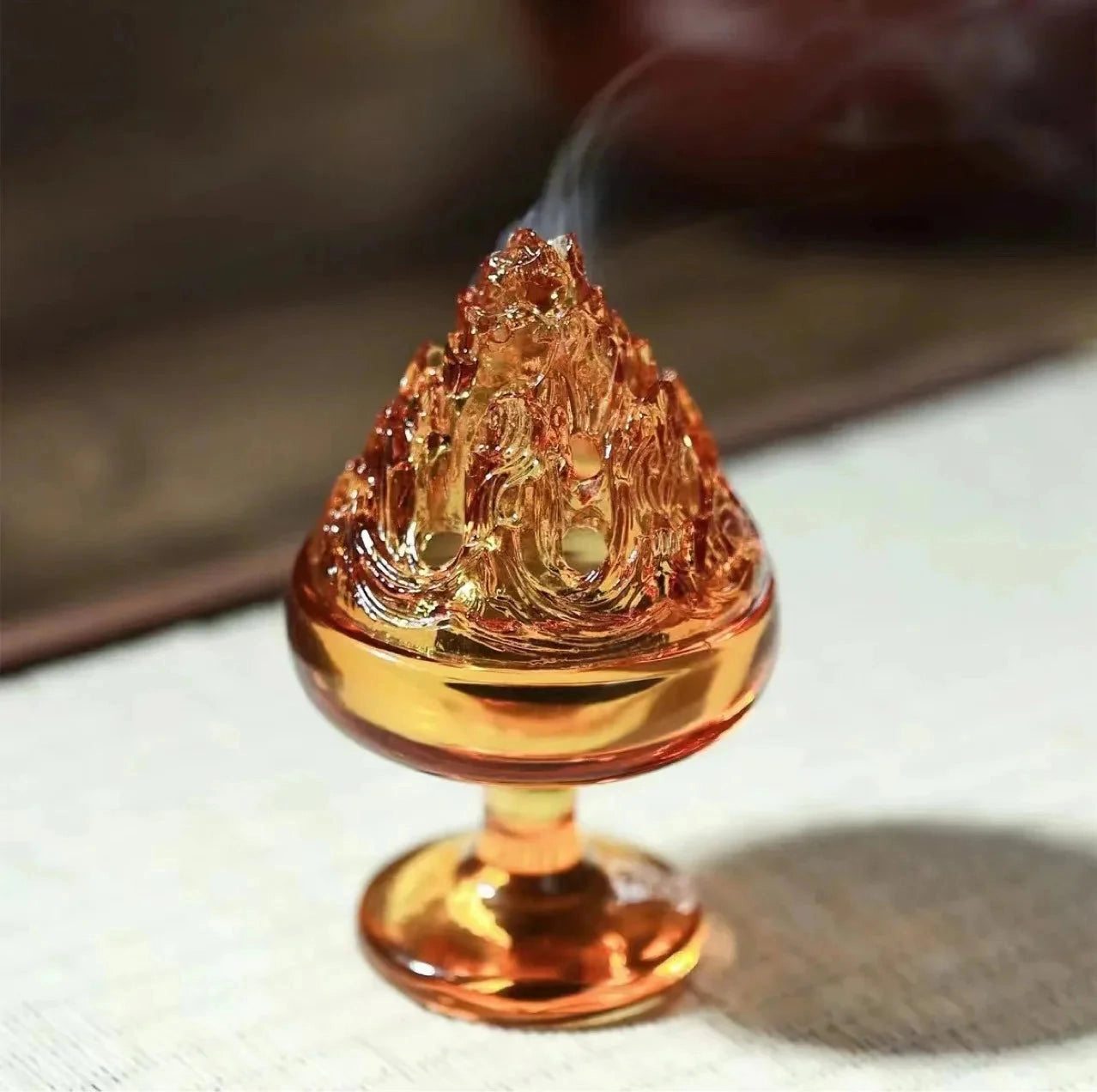 Elegant glass incense burner with amber hue, perfect for Zen home decor.